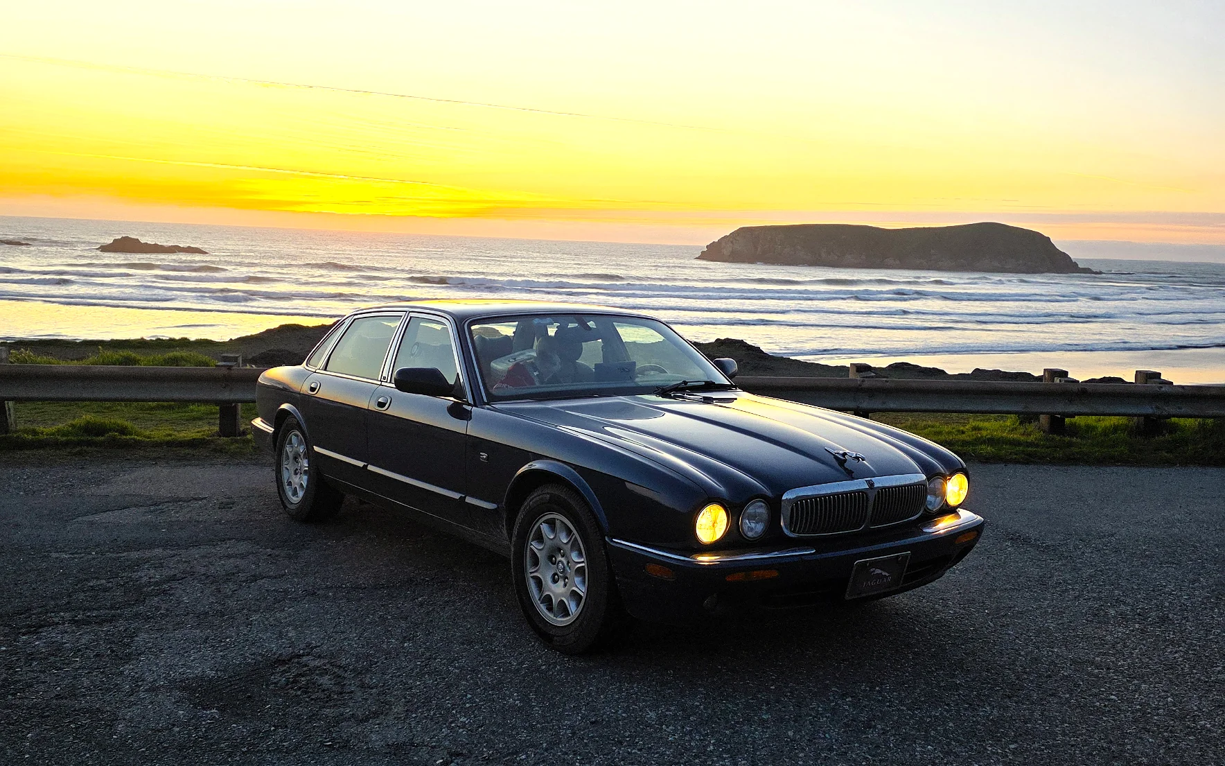 Sapphire Blue Jaguar X308 on the Oregon coast at sunset
